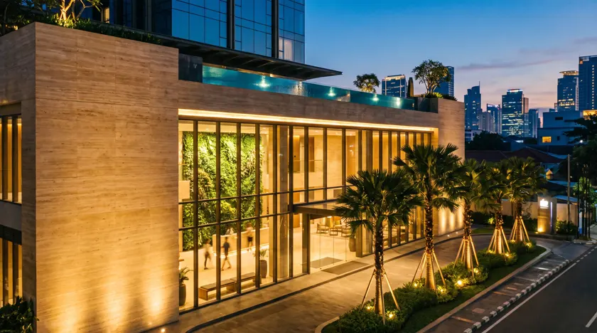 Ethelia Club concept — urban wellness and longevity club building in Jakarta at dusk